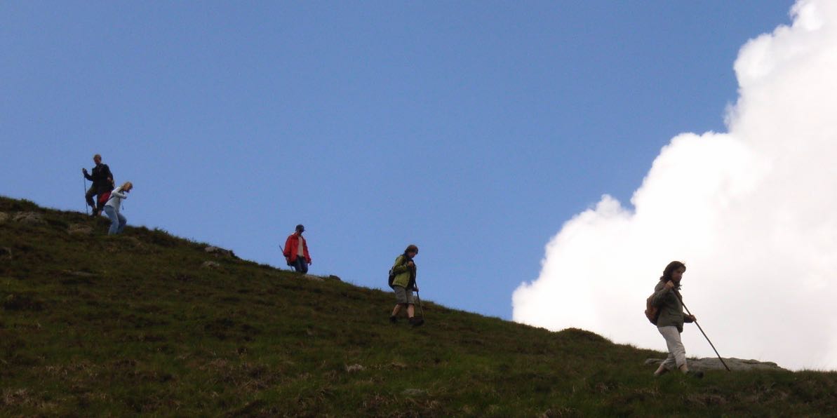 Frauen-wandern-leichtfuessig-den-Berghang-hinunter